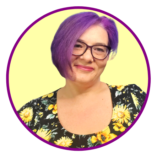 woman with asymmetrical purple hair, glasses, and a sunflower top