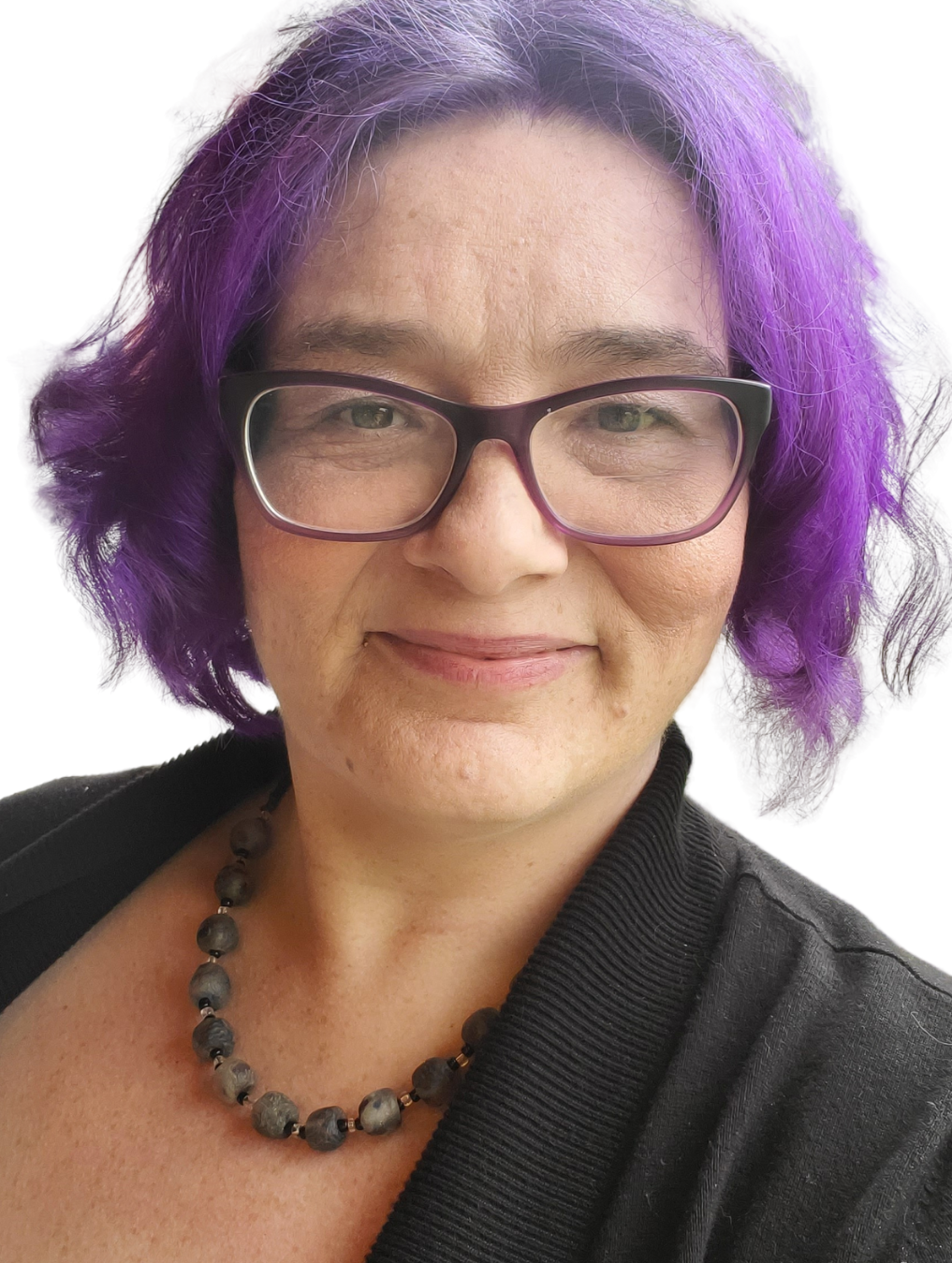 Kat, a woman with purple hair and glasses, wears a black necklace and smiles at the camera.